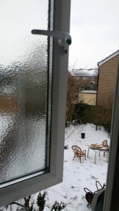 A thick layer of frozen rain on a window