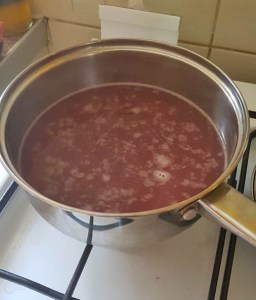 pasteurising grape juice in a pan